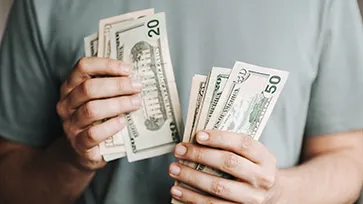 Man holding dollar bills